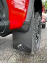 PKG Chevy 2500 ZR2 Bison Rear drill‑less mud flaps with semi-gloss black powder coated Bison weights & color behind, 2024 – Current