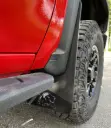PKG Chevy 2500 ZR2 Bison Front drill‑lessmud flaps with semi-gloss black powder coated Bison weights & color behind, 2024 – Current 