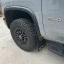 PKG Chevy 2500 ZR2 Front drill‑less mud flaps with semi-gloss black powder coated ZR2 weights & color behind, 2024 – Current 
