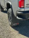 PKG Chevy 2500 ZR2 Rear drill‑less mud flaps with semi-gloss black powder coated ZR2 weights & color behind, 2024 – Current 