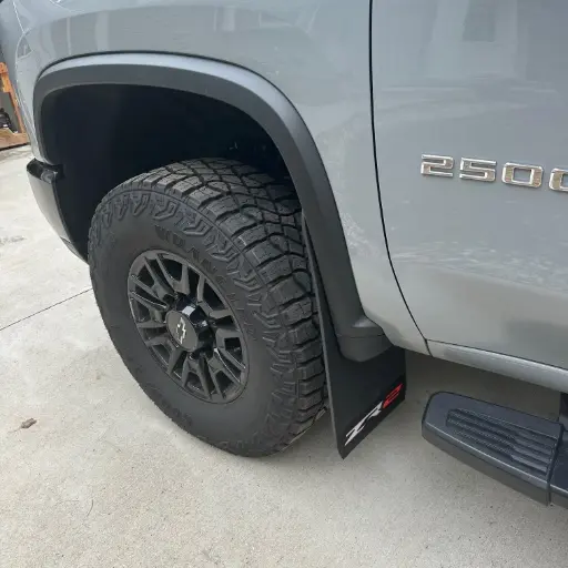 [009407] PKG Chevy 2500 ZR2 Front drill‑less mud flaps with semi-gloss black powder coated ZR2 weights & color behind, 2024 – Current 